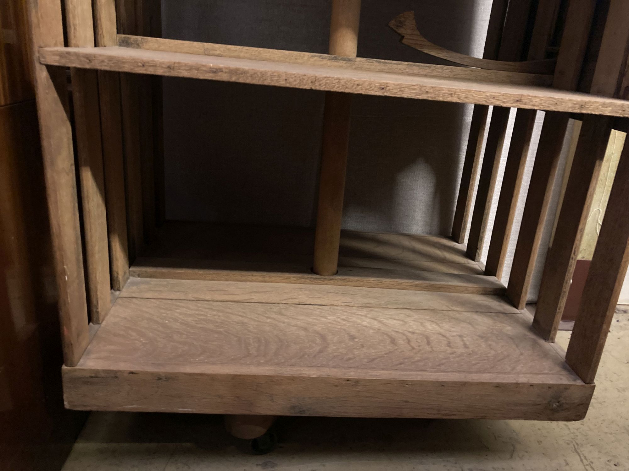 An Arts & Crafts light oak drop flap revolving bookcase, with a folding reading slope, width 68cm, depth 56cm, height 90cm